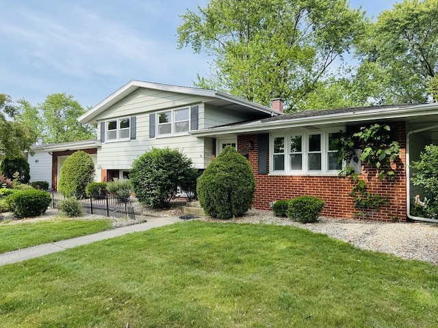 18947 Ridgewood Ave, Lansing, IL 60438 - split level home featuring brick siding, a front lawn, and a chimney