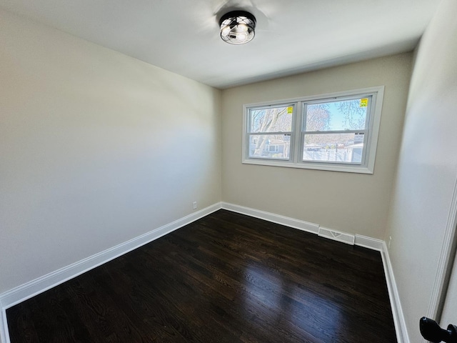 empty room featuring dark hardwood / wood-style flooring