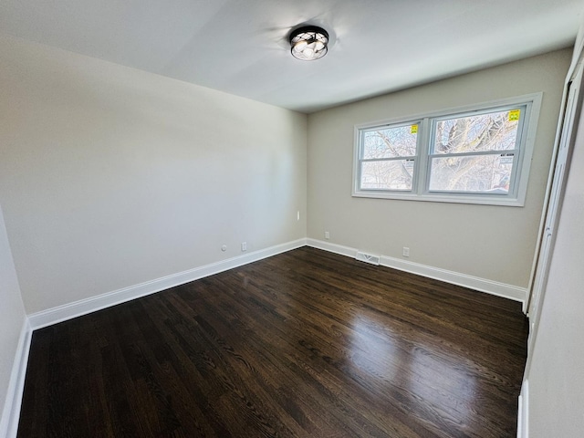 spare room featuring dark hardwood / wood-style flooring