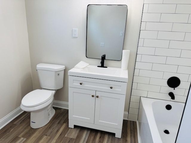 full bathroom featuring toilet, vanity, shower / washtub combination, and hardwood / wood-style floors