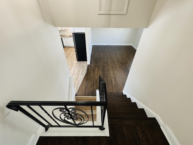 staircase with hardwood / wood-style flooring