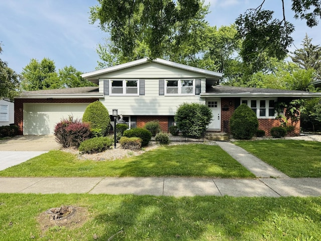 18947 Ridgewood Ave, Lansing, IL 60438 - split level home featuring an attached garage, brick siding, driveway, and a front lawn