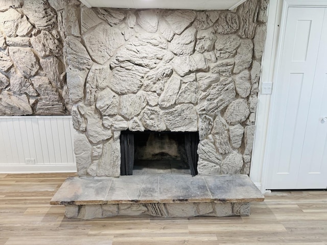 details with hardwood / wood-style floors and a fireplace