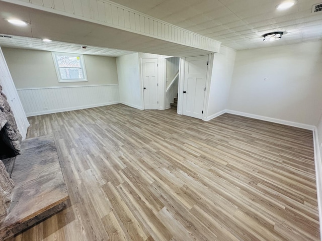 18947 Ridgewood Ave, Lansing, IL 60438 - below grade area with light wood-type flooring, stairs, a fireplace, and a wainscoted wall