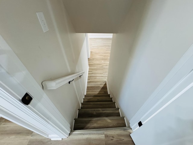 staircase with hardwood / wood-style flooring