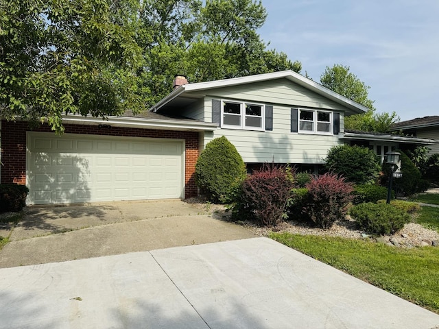 18947 Ridgewood Ave, Lansing, IL 60438 - split level home with driveway, brick siding, a garage, and a chimney