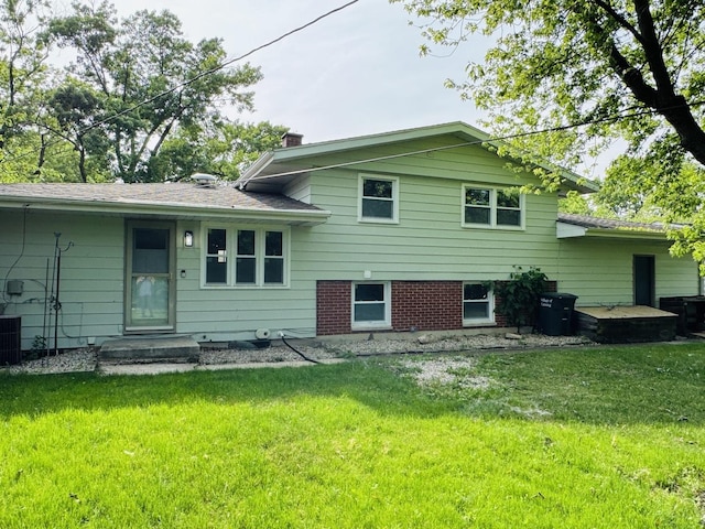 18947 Ridgewood Ave, Lansing, IL 60438 - rear view of property with a lawn and a chimney