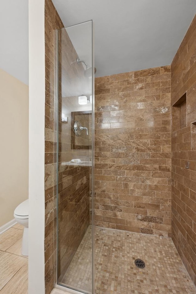 bathroom with an enclosed shower and toilet