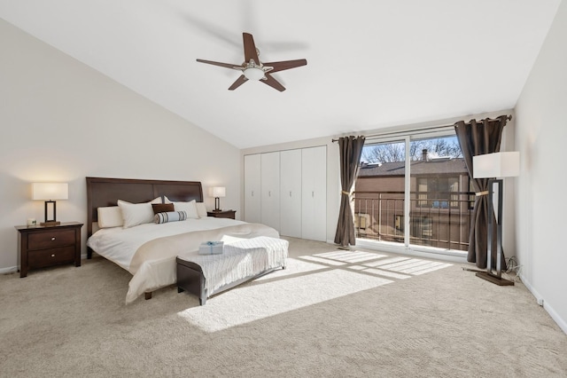 carpeted bedroom featuring vaulted ceiling, a closet, and ceiling fan