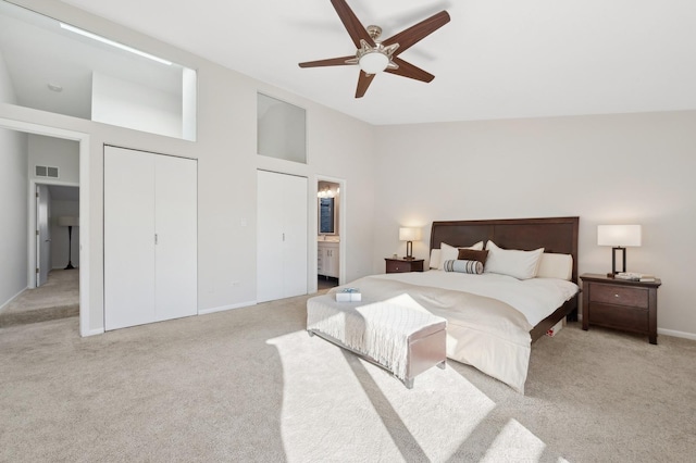 bedroom with connected bathroom, high vaulted ceiling, ceiling fan, light carpet, and a closet