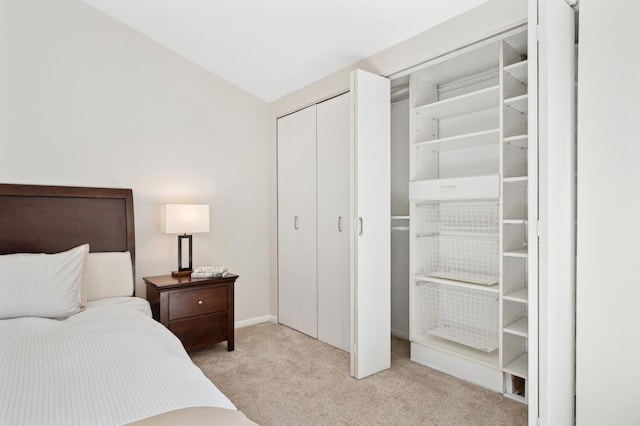 bedroom with light colored carpet and a closet