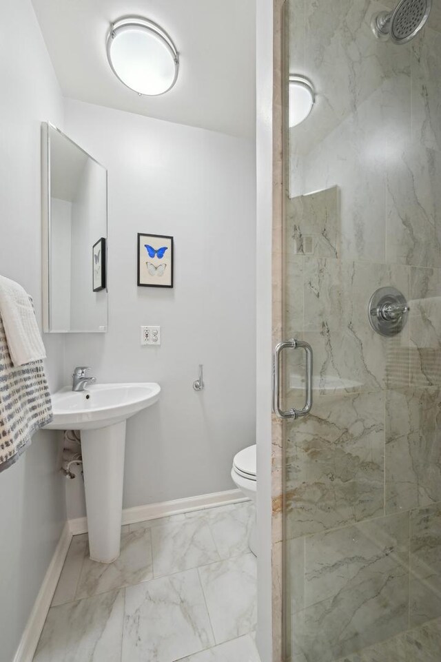 bathroom featuring toilet, sink, and walk in shower