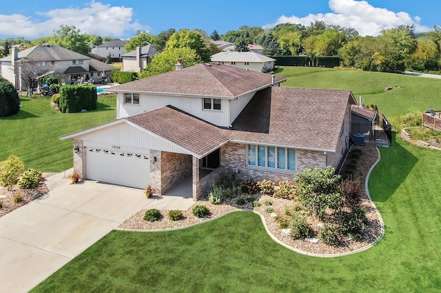 view of front of house with a garage and a front lawn