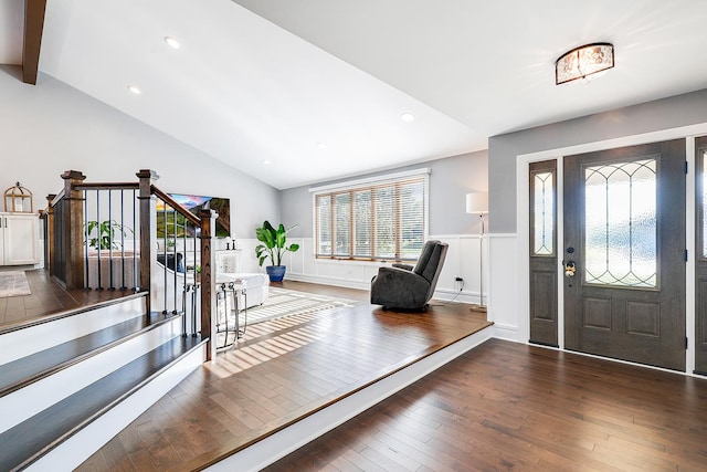 foyer with dark hardwood / wood-style flooring and lofted ceiling with beams