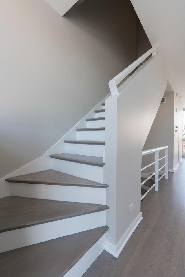 stairs featuring hardwood / wood-style floors