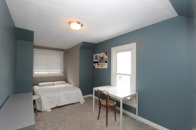 carpeted bedroom with vaulted ceiling