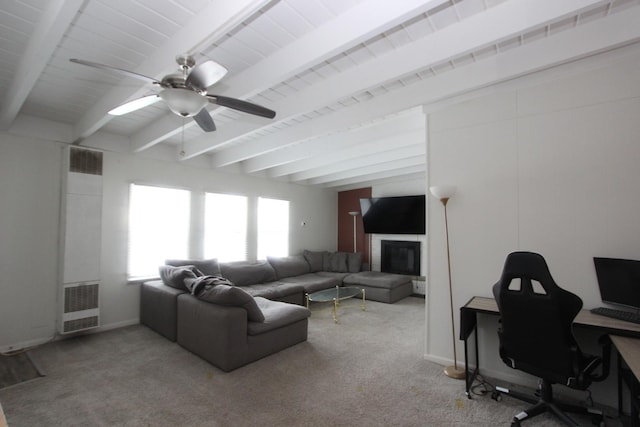 living room featuring beam ceiling, a fireplace, light colored carpet, and ceiling fan