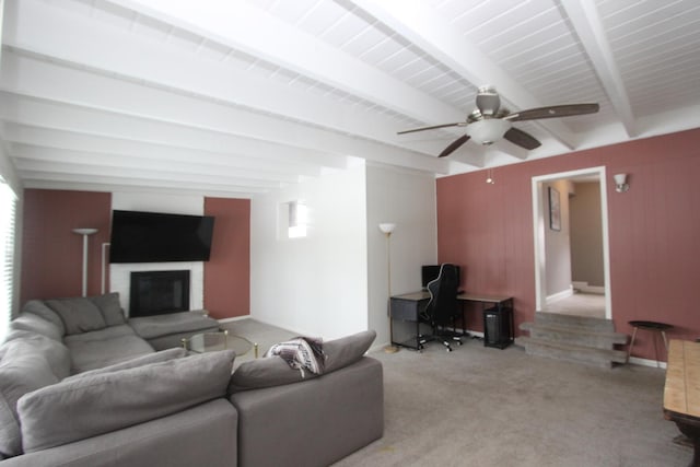 living room featuring beamed ceiling, light carpet, and ceiling fan