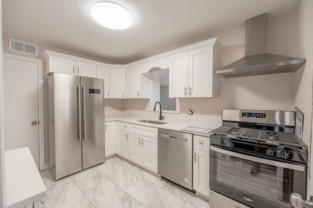 kitchen with sink, white cabinets, wall chimney exhaust hood, and appliances with stainless steel finishes