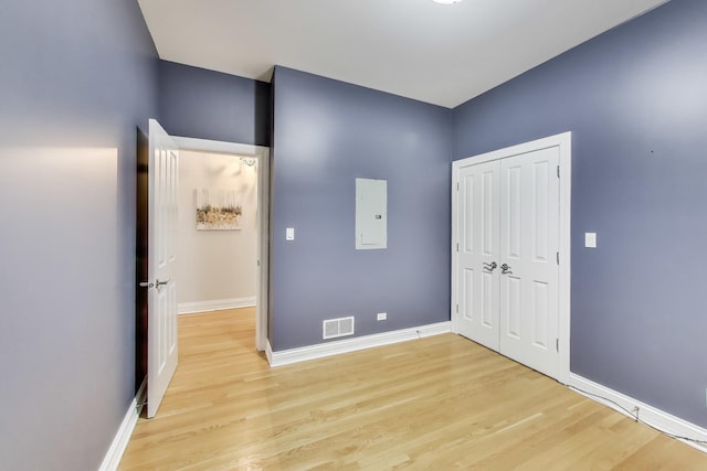 unfurnished bedroom featuring light hardwood / wood-style flooring and a closet