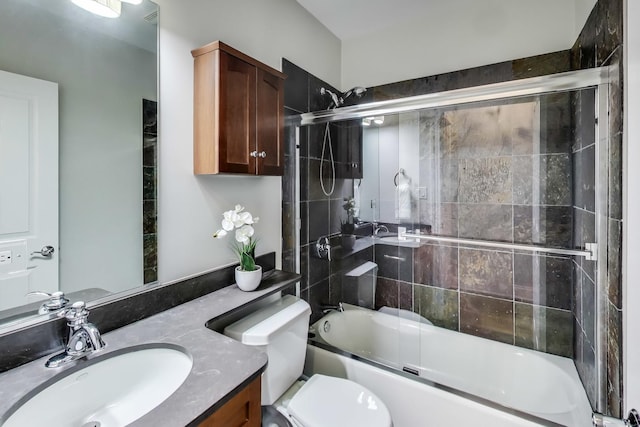 full bathroom with vanity, combined bath / shower with glass door, and toilet