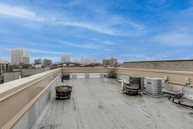 view of patio with a balcony and central air condition unit