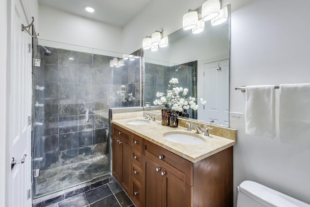 bathroom featuring vanity, tile patterned floors, a shower with door, and toilet