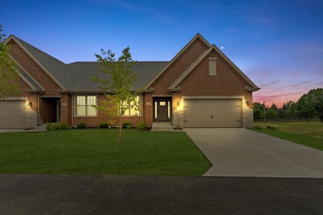 craftsman inspired home featuring a garage and a lawn