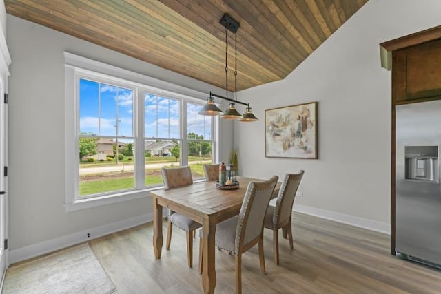 dining area with hardwood / wood-style floors, vaulted ceiling, and wooden ceiling