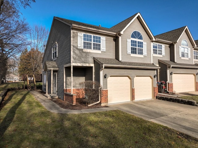 view of front of home with a front yard and a garage