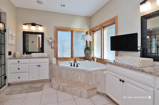 bathroom featuring vanity, independent shower and bath, and tile patterned flooring