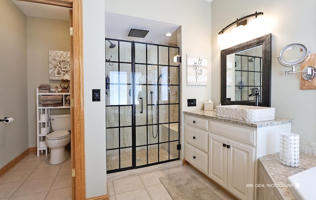 bathroom featuring toilet, tile patterned flooring, a tile shower, and vanity