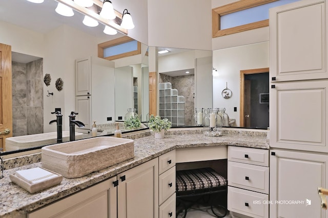 bathroom featuring vanity and a tile shower