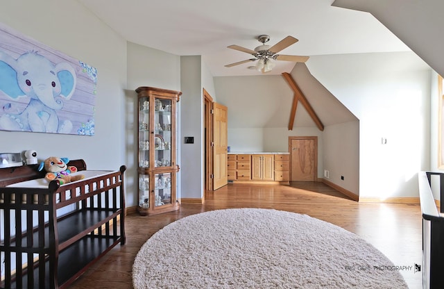 bedroom with vaulted ceiling, ceiling fan, and hardwood / wood-style floors