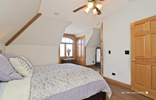 bedroom with vaulted ceiling, ceiling fan, and dark wood-type flooring