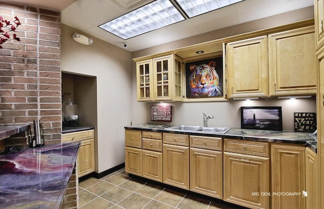 kitchen featuring light tile patterned floors and sink