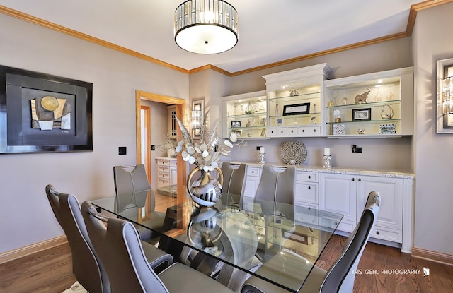 dining space with dark hardwood / wood-style floors and ornamental molding