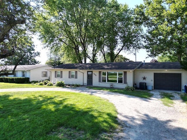 single story home with central air condition unit, a front lawn, and a garage