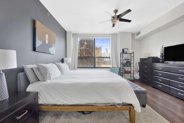 bedroom featuring ceiling fan and dark hardwood / wood-style flooring