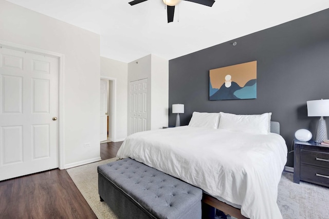 bedroom with ceiling fan, a closet, and dark hardwood / wood-style flooring