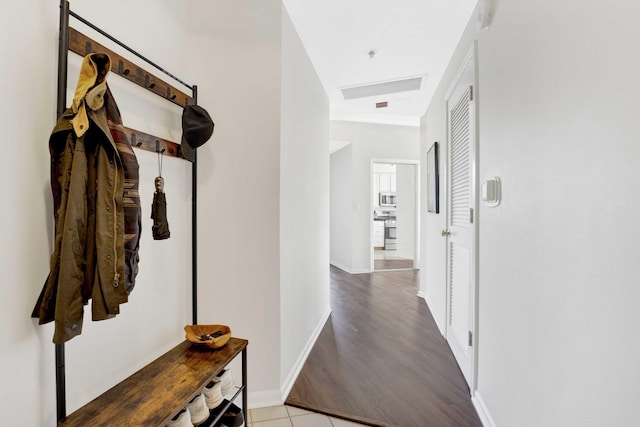 corridor featuring light tile patterned floors