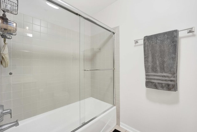 bathroom with combined bath / shower with glass door