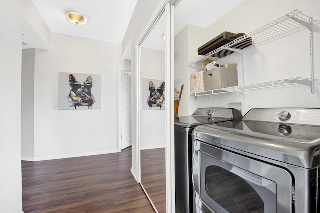 washroom with washer and clothes dryer and dark hardwood / wood-style floors