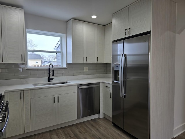 kitchen featuring tasteful backsplash, stainless steel fridge with ice dispenser, sink, and dishwasher