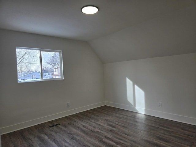 bonus room featuring lofted ceiling and dark hardwood / wood-style floors