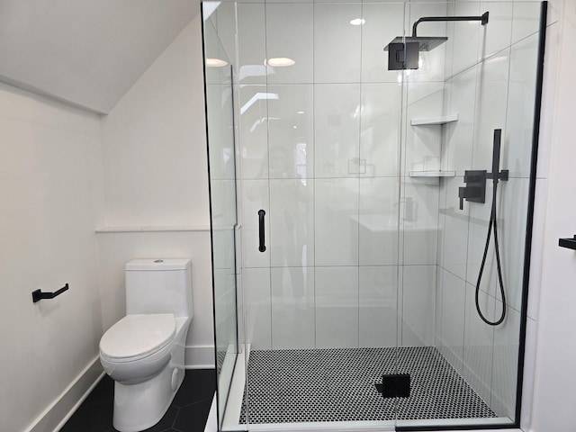 bathroom featuring tile patterned flooring, an enclosed shower, and toilet