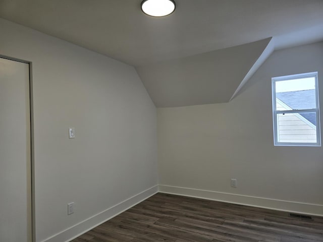 bonus room with lofted ceiling and dark hardwood / wood-style floors