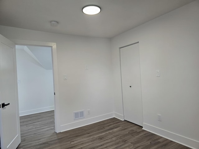 unfurnished bedroom featuring dark hardwood / wood-style floors