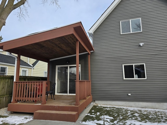 snow covered property featuring a deck