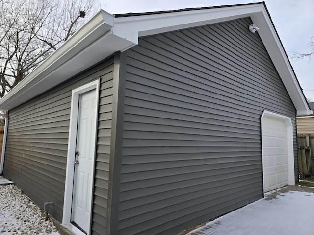 view of property exterior featuring a garage and an outdoor structure